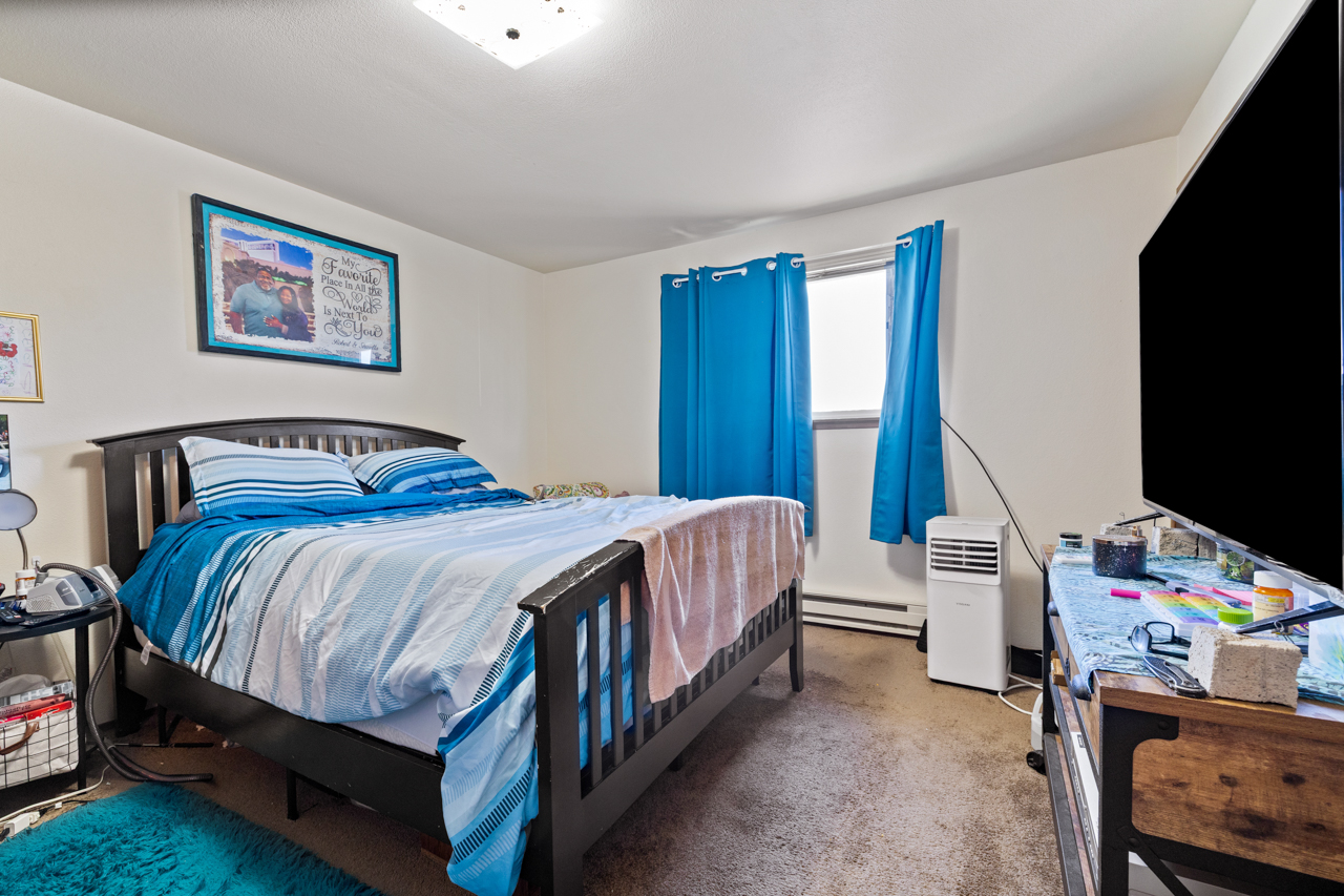Unit bedroom with carpet and window